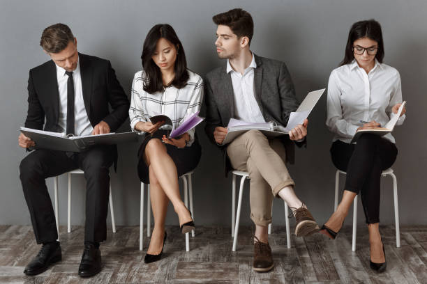 istock focused multicultural business people with folders and notebooks waiting for job interview 1007144918