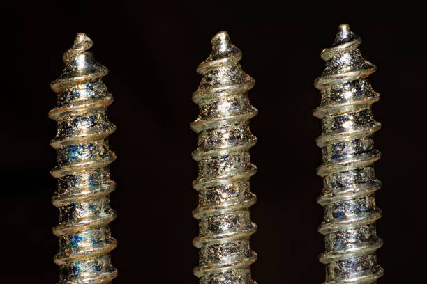 istock part of 3 screws closed up (black background) 1007148776