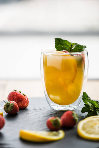 istock juicy summer cocktail with strawberries and mint on slate board 1007156588