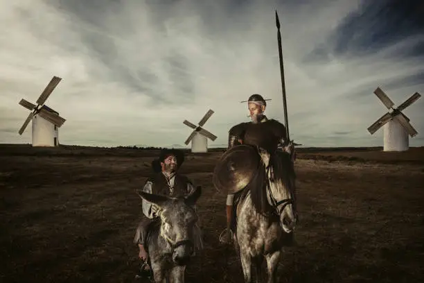 Don Quixote and Sancho panza riding through fields in La Mancha Spain