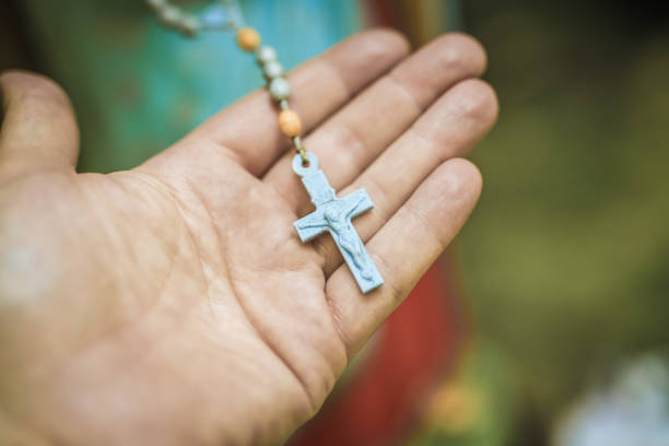 istock Rosary in hand, cross, figurine 1007165870