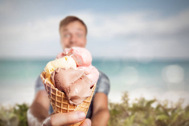 istock Man holding a large ice cream cone 1007171710