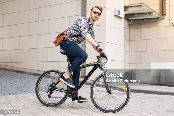 Smart Handsome Man Riding A Bike In The City Stock Photo - Download Image Now - Cycling, Bicycle, Men