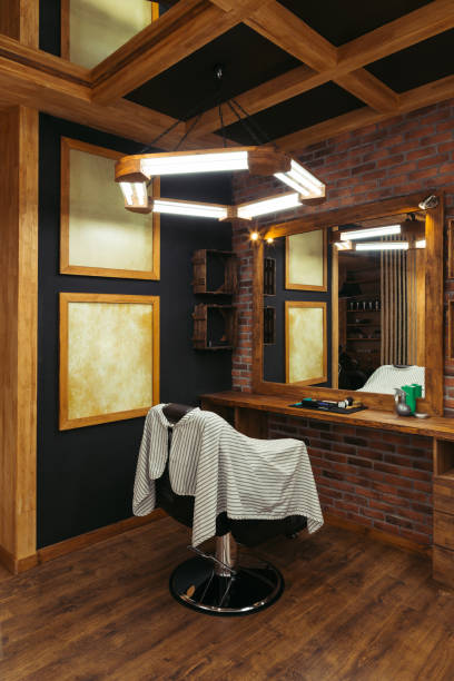 istock modern empty barbershop interior with chair, mirror and lamps 1007175470