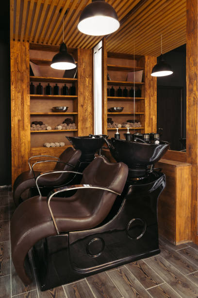 istock empty leather chairs and sinks in modern hair salon 1007175494