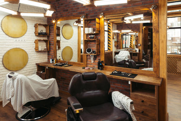istock empty chairs reflected in mirrors in modern barbershop 1007175504