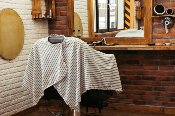 istock empty chair at modern barber shop interior 1007175526