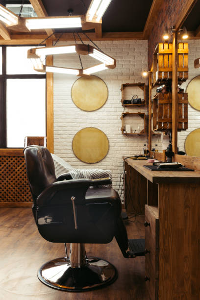 istock empty chair, mirrors and lamps in modern barbershop interior 1007175540