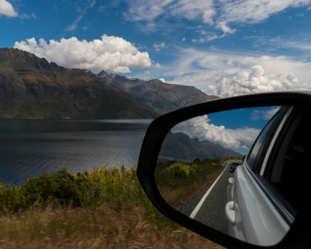 istock Looking out car window driving past lake 1007178876