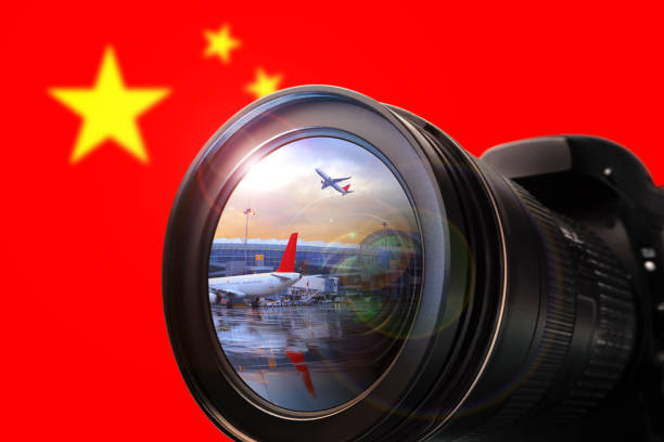 The camera in front of the flag background.