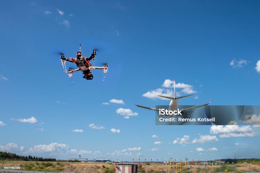 A drone flying near an airport A drone flying near an airport. It is illegaly to fly drones near airport. This is a composite image to serve as a concept. Drone Stock Photo