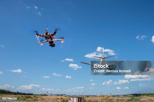 A Drone Flying Near An Airport Stock Photo - Download Image Now - Drone, Airplane, Airport