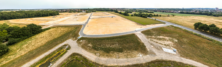 Panorama in high resolution, composed of photos with the drone, with a view of a new development with several streets and dead ends, undeveloped, aerial view