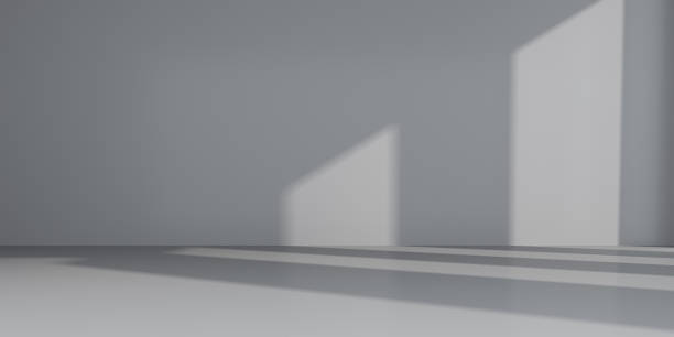 istock Abstract of empty room space with sun light cast the window shadow on the wall and floor,Perspective of minimal design architecture.3d render 1007193970