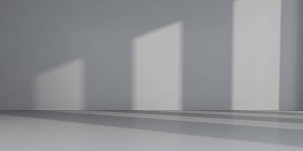 istock Abstract of empty room space with sun light cast the window shadow on the wall and floor,Perspective of minimal design architecture.3d render 1007194006