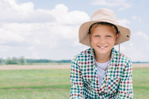 istock adorable child in panama hat smiling at camera on farm 1007195066