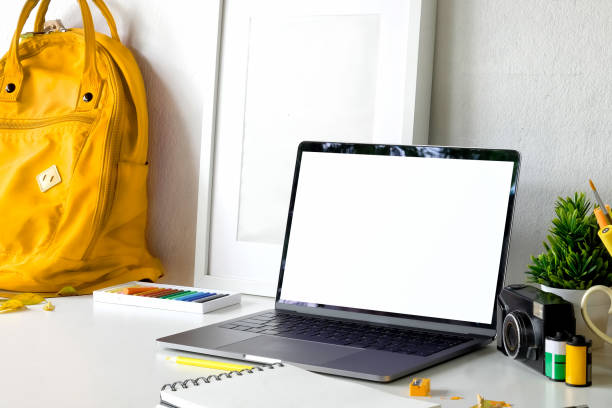 istock Photographer workspace with blank screen laptop on white desk. 1007195128