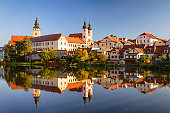 View of Telc across pond with reflections, southern Moravia, Czech Republic.