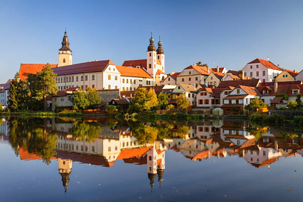 View of Telc across pond with reflections, southern Moravia, Czech Republic. stock photo