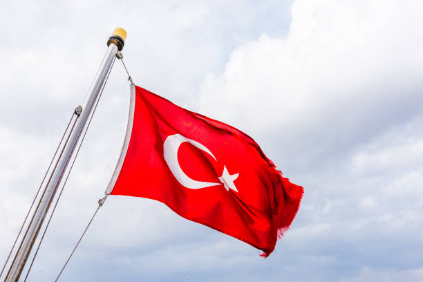 istock Turkish flag waving against the  blue sky 1007199528