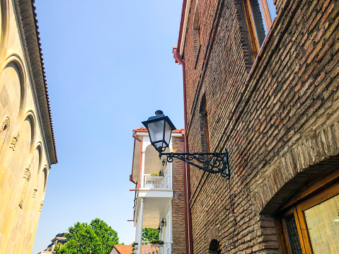 TBILISI, GEORGIA - July 10, 2018: Old Street , lantern on a brick wall in Abanotubani district of Tbilisi, Georgia