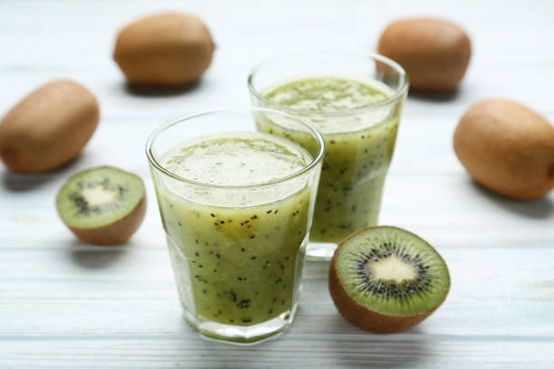 istock Fresh kiwi smoothie in glass on wooden table 1007209796