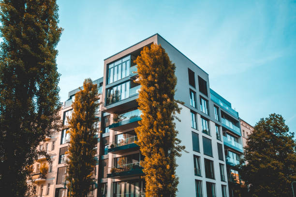 istock beautiful modern apartment building with giant trees 1007210452