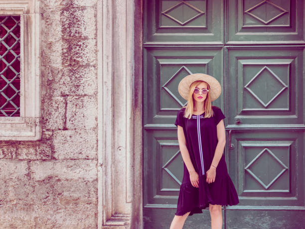 istock Young attractive woman poses  in front of wall 1007214194