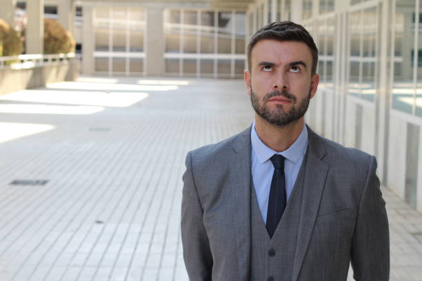 istock Fed up businessman rolling his eyes 1007214228