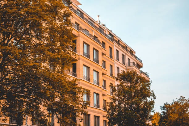 istock orange apartment building with big tree 1007214296