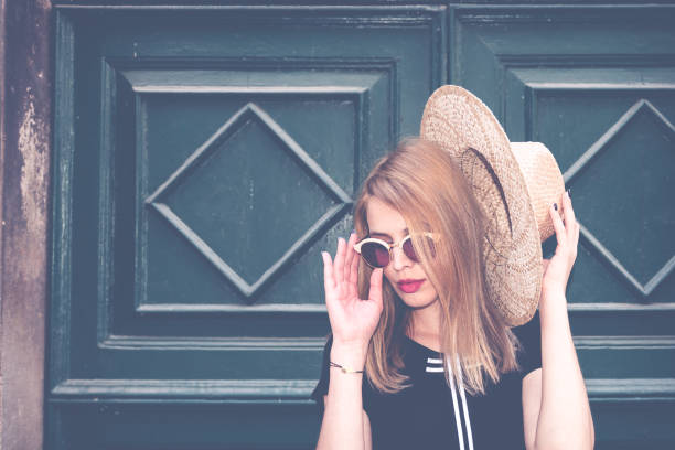 istock Young attractive woman poses  in front of wall 1007214600