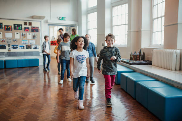 istock School Children Walking Through the Hall with their Teachers 1007220870