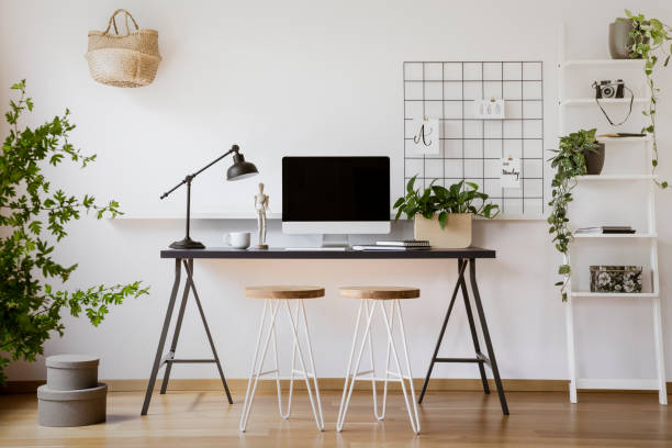 istock Stools at desk with lamp and computer desktop in freelancer's interior with plants. Real photo 1007226162