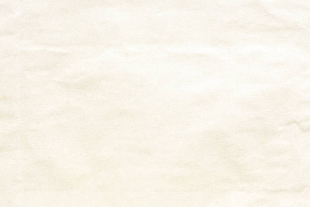 istock Old crumpled pale yellow  paper texture 1007227182