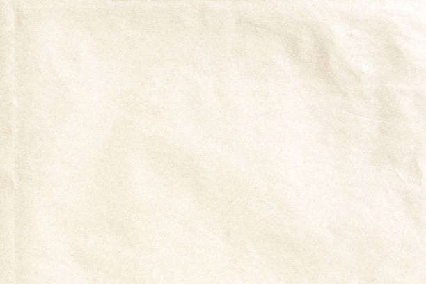 istock Old crumpled pale yellow  paper texture 1007227288