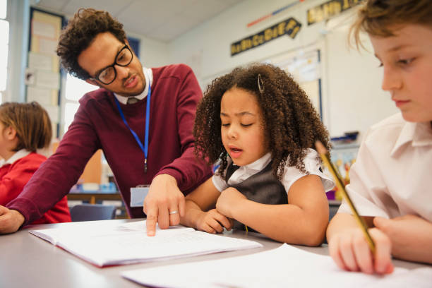 istock Schoolgirl Works with her Teacher in Elementary Class 1007227504