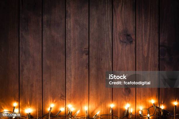 Empty Rustic Wooden Table With Christmas Lights Border Stock Photo - Download Image Now