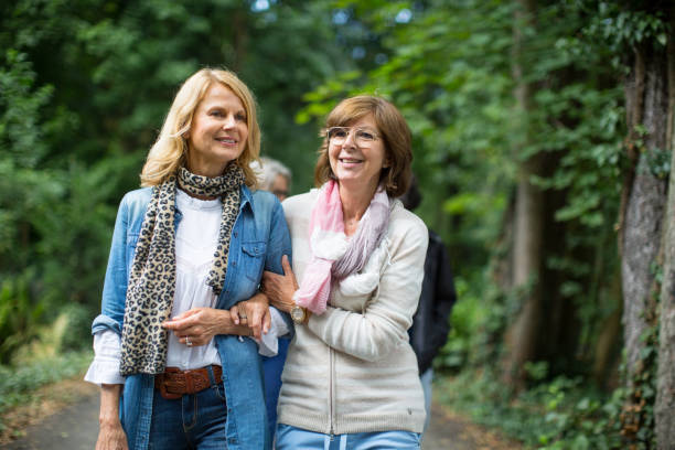 istock Smiling female friends walking in forest 1007230344