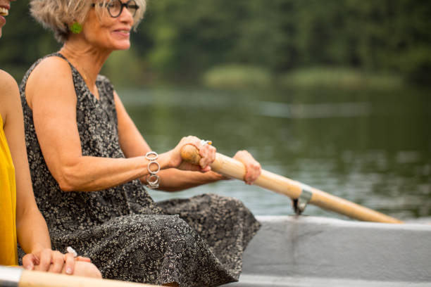 istock Active mature woman rowing boat in lake 1007230740