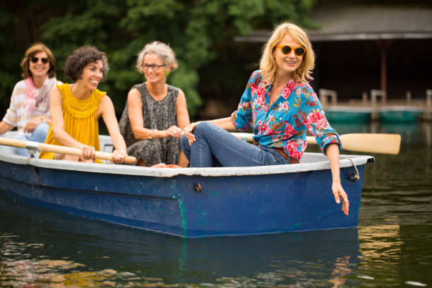 istock Woman touching water while boating with friends 1007230836
