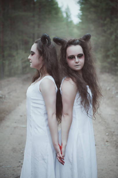 istock Two twins demons with horns in forest 1007231614