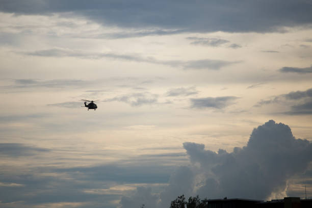 istock A silhouette of helicopter on the sky during sunset time. 1007239228