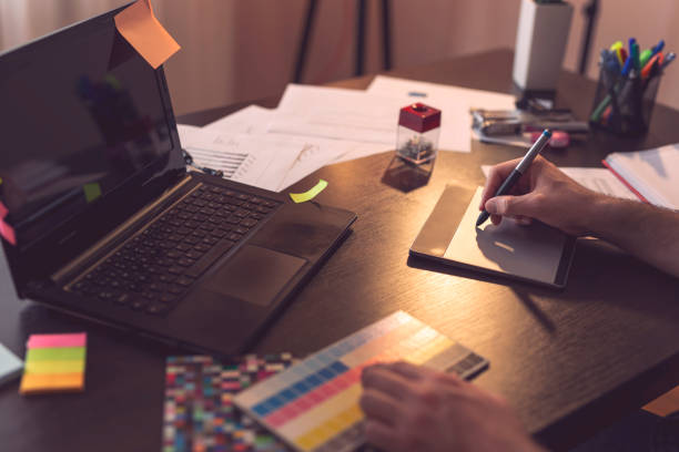 istock Graphic designer choosing a color from a color palette 1007246820
