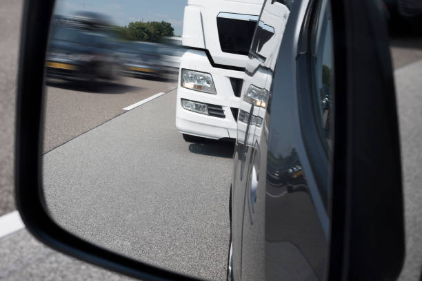 istock Traffic on highway - looking through rear view mirror 1007247340