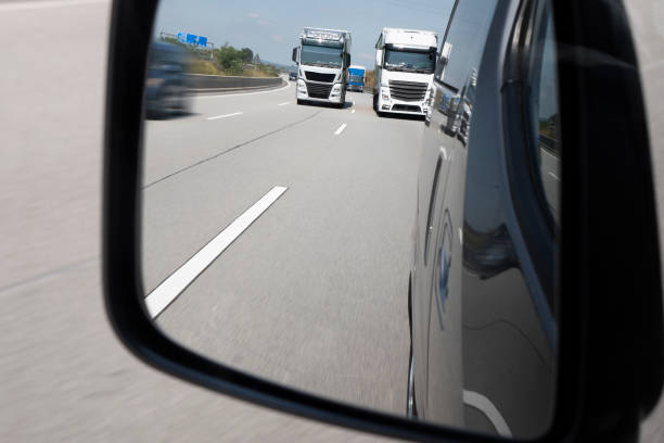 istock Traffic on highway - looking through rear view mirror 1007247446