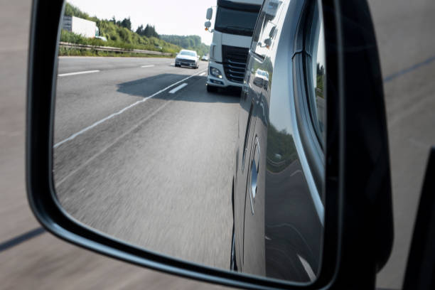 istock Traffic on highway - looking through rear view mirror 1007247470