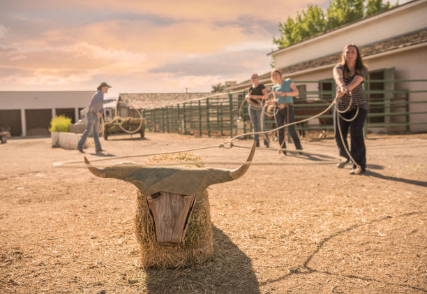 Young cowgirls training roping at farm