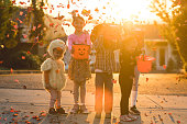 Multiethnic group of kids trick or treating