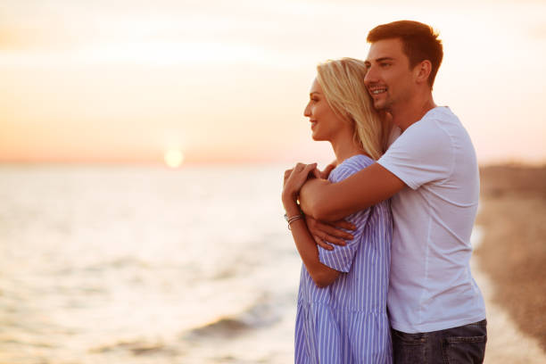 istock Young happy couple on seashore. 1007257638
