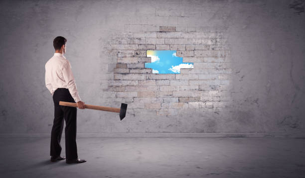 istock Business man hitting brick wall with hammer 1007257902